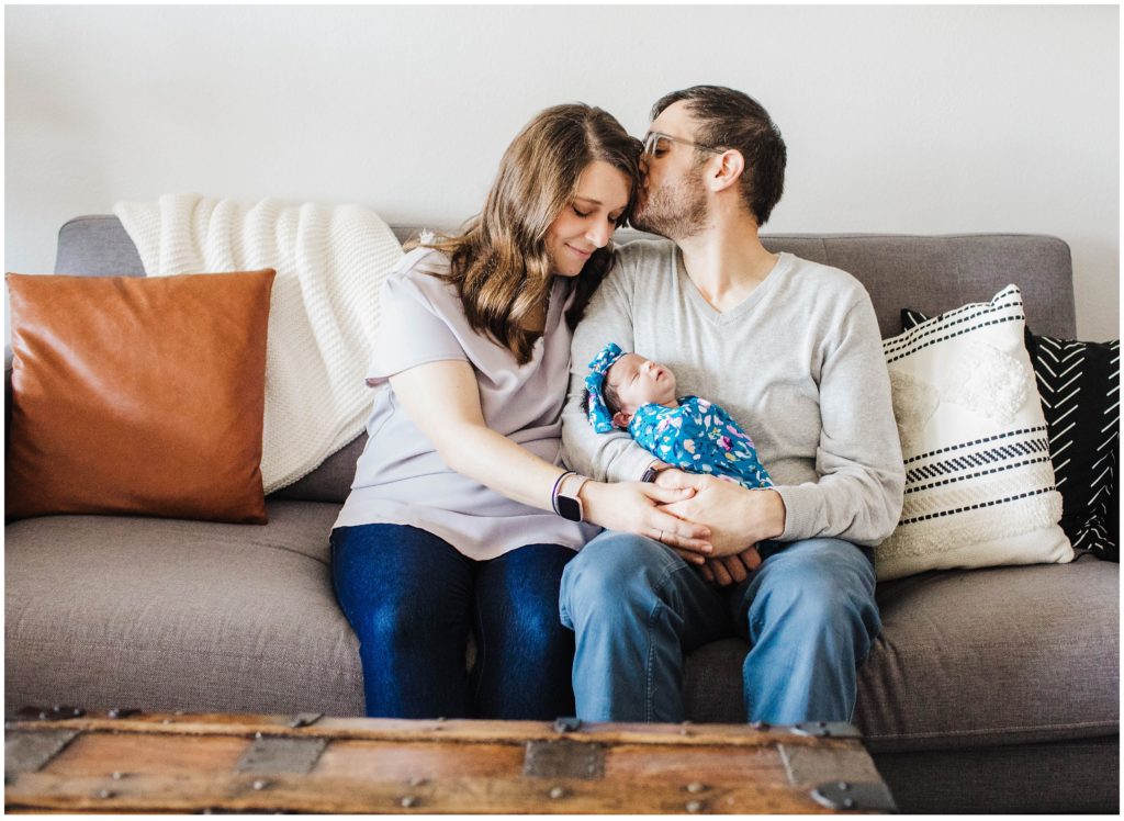 Dad kissing mom during lifestyle newborn session