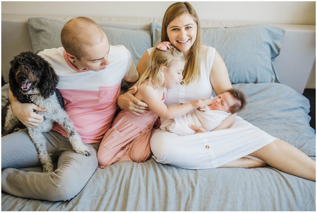 Family taking photos during newborn photoshoot
