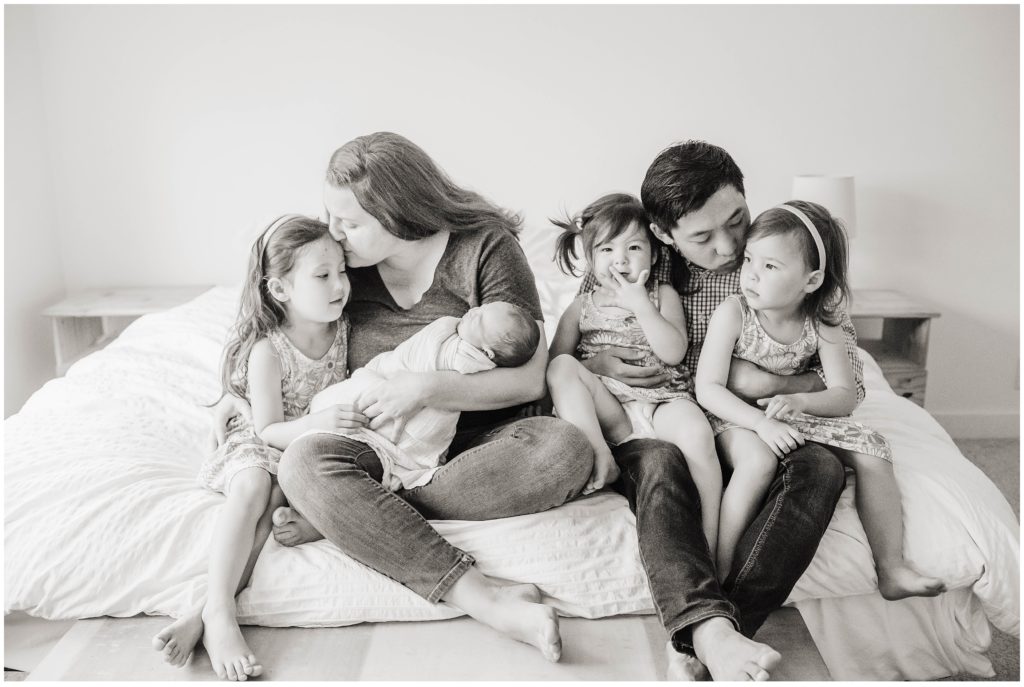 Image of family loving on their children during a newborn photoshoot