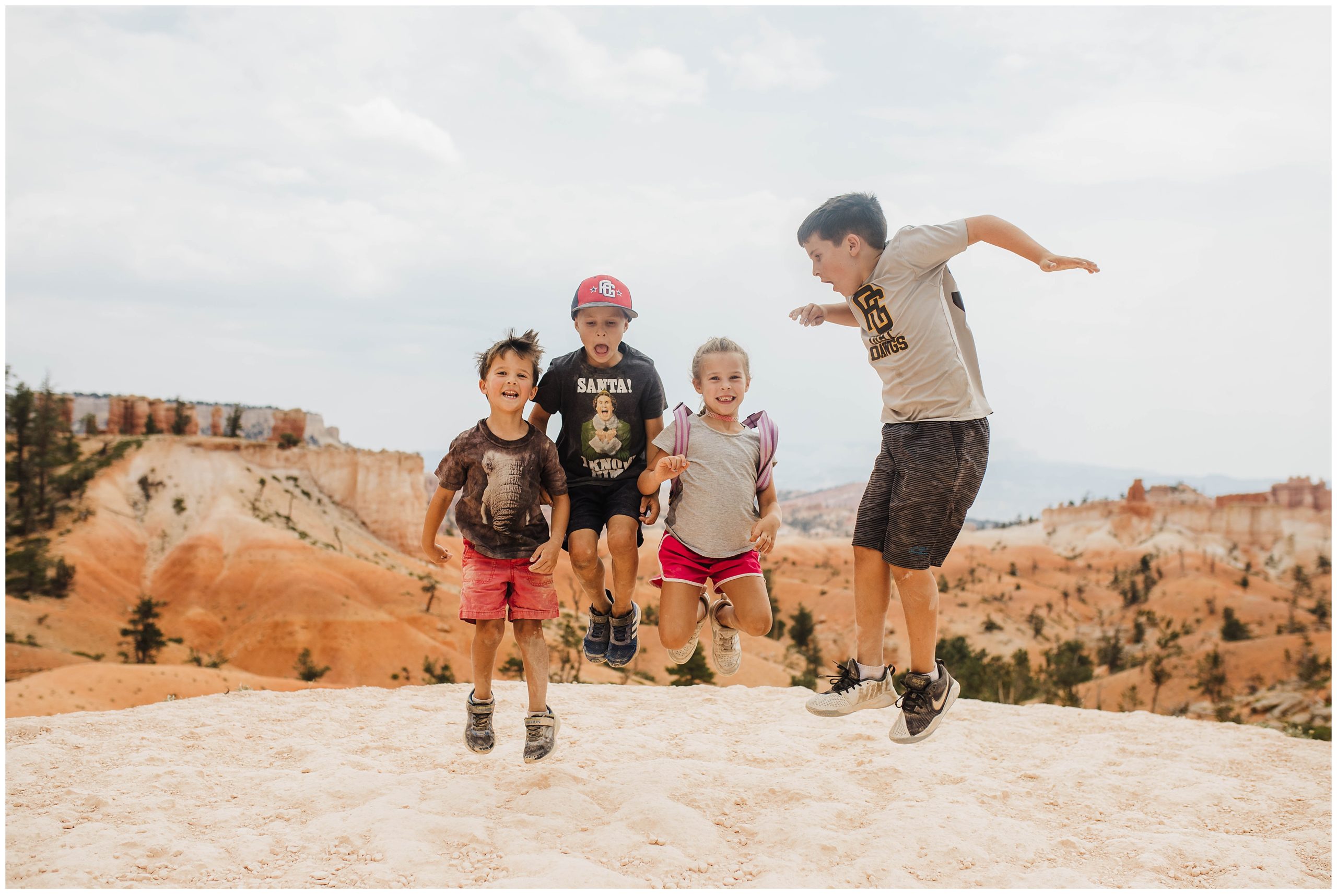 Kids jumping at Bryce Canyon while on a road trip