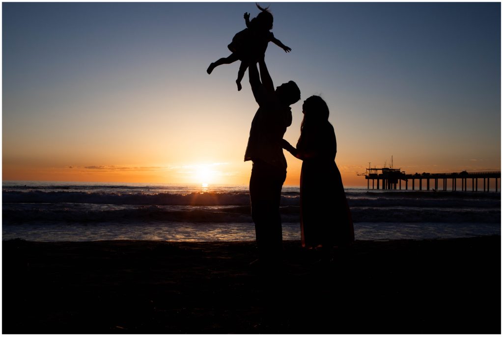 Silhouette image of family on the beach