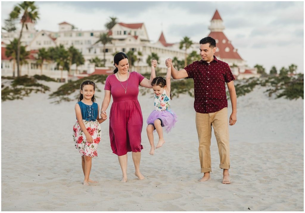Family of four having fun during family photos on Coronado Beach